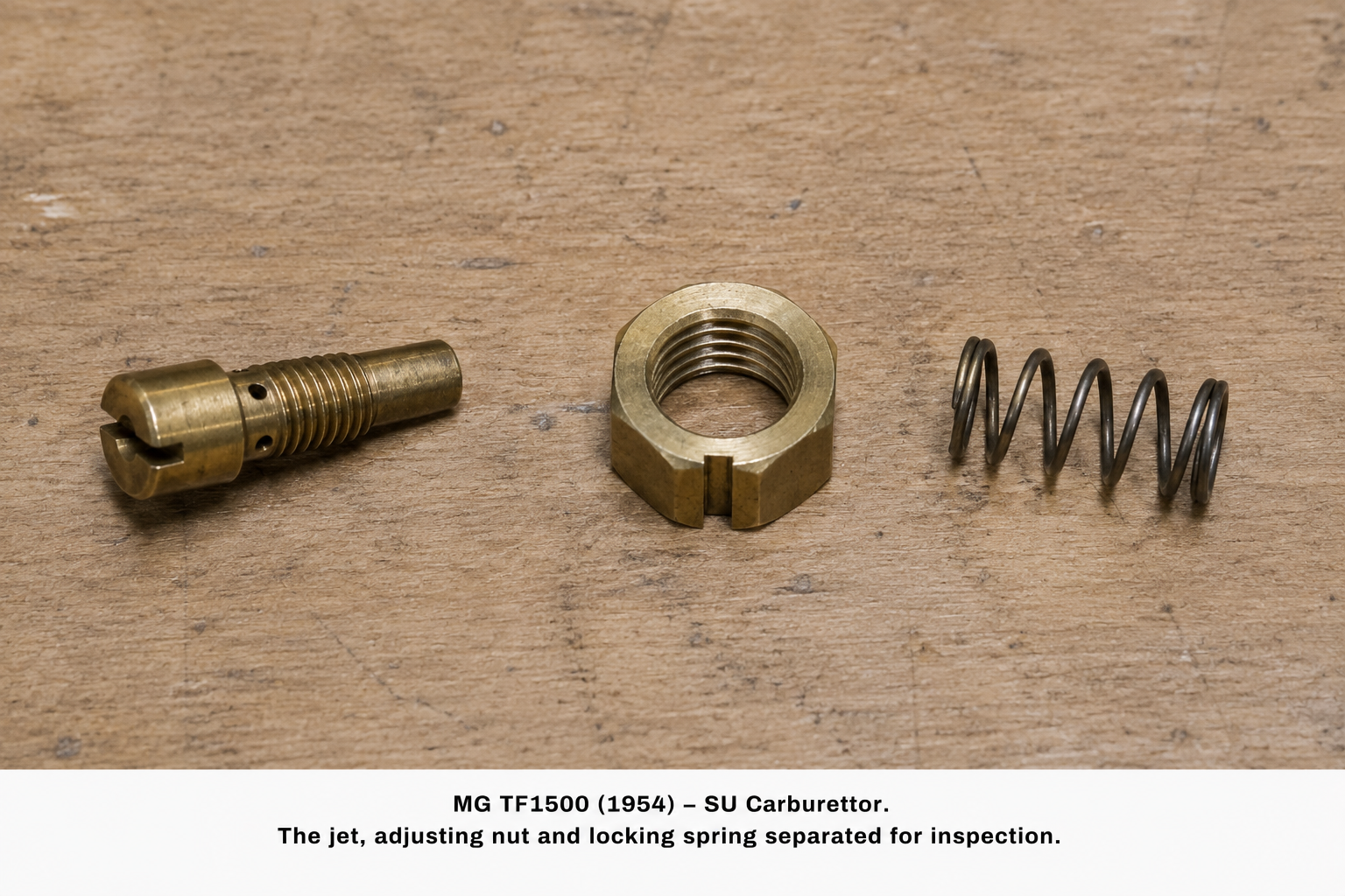 The jet, adjusting nut and locking spring separated for inspection.