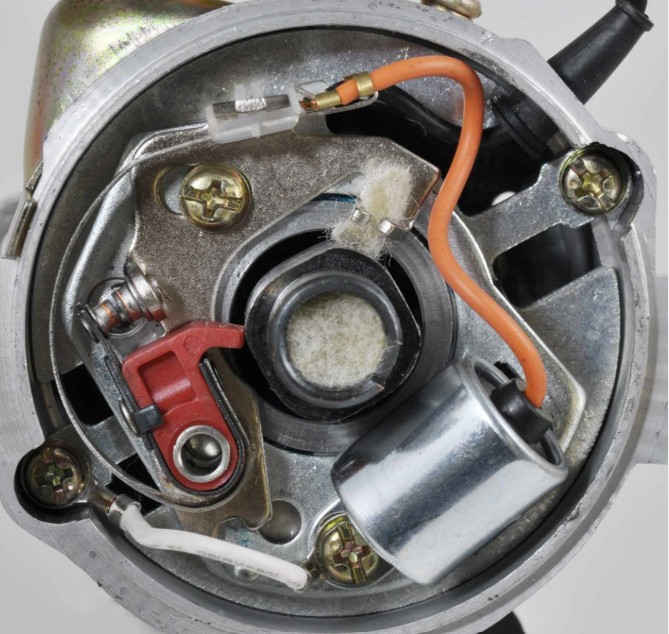 Inside a classic distributor showing points, cam and advance weights