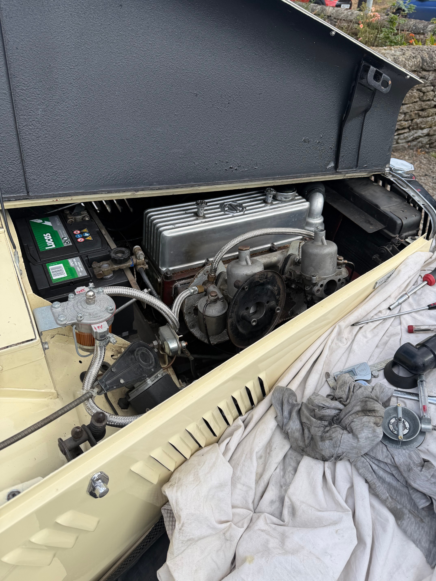 A flow meter held against an SU carburettor intake